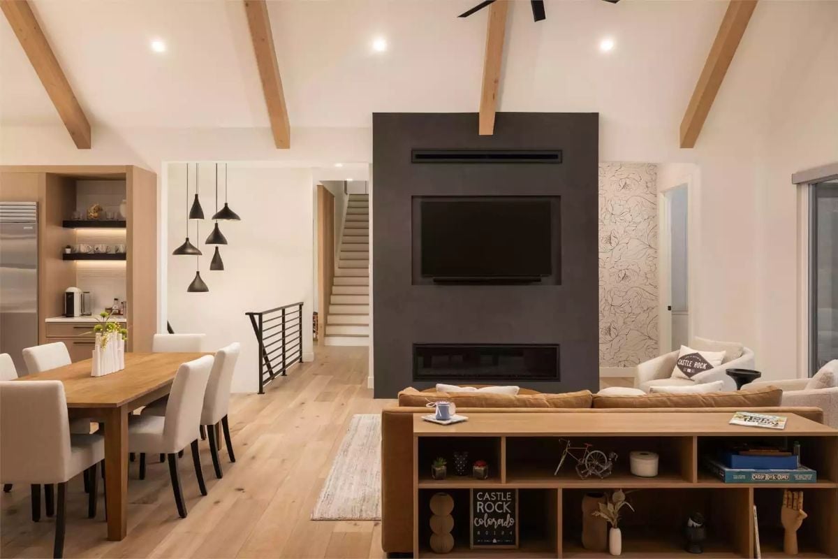 Dark Fireplace Surround Anchors the Room Without Competing with the Wood
