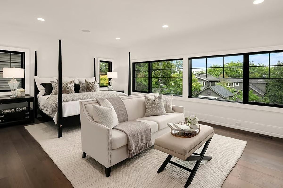Four-Post Bed and Black Window Frames Doing the Heavy Lifting in This Master Suite