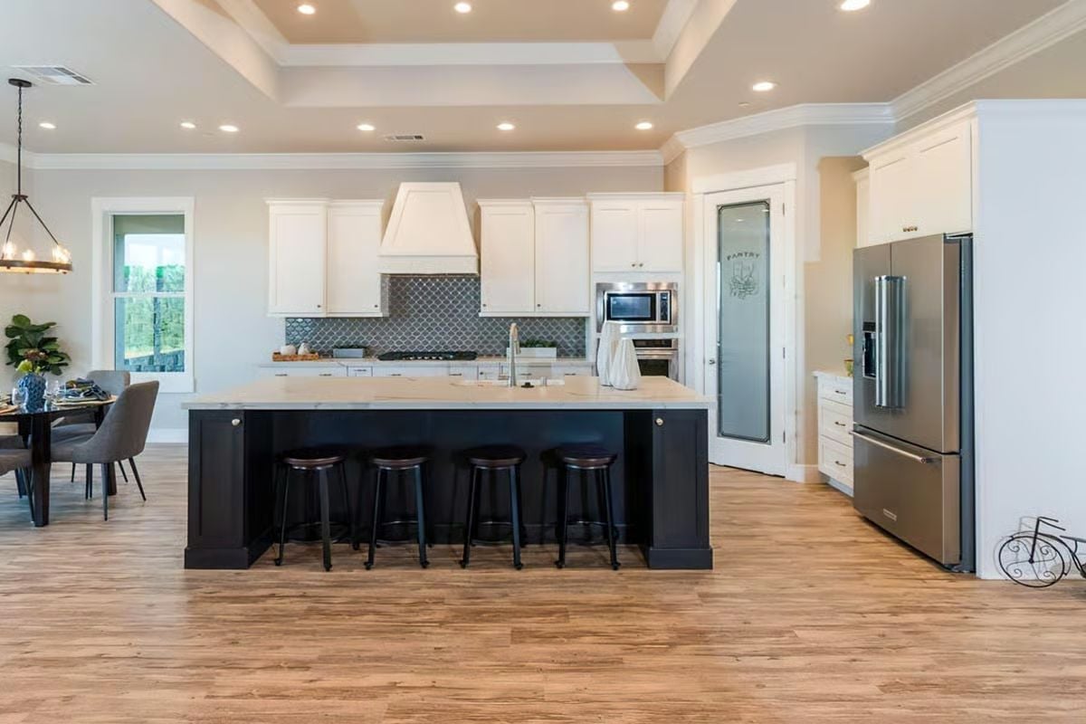 Dark Island Base Against White Cabinetry Pulls the Whole Kitchen Into Focus
