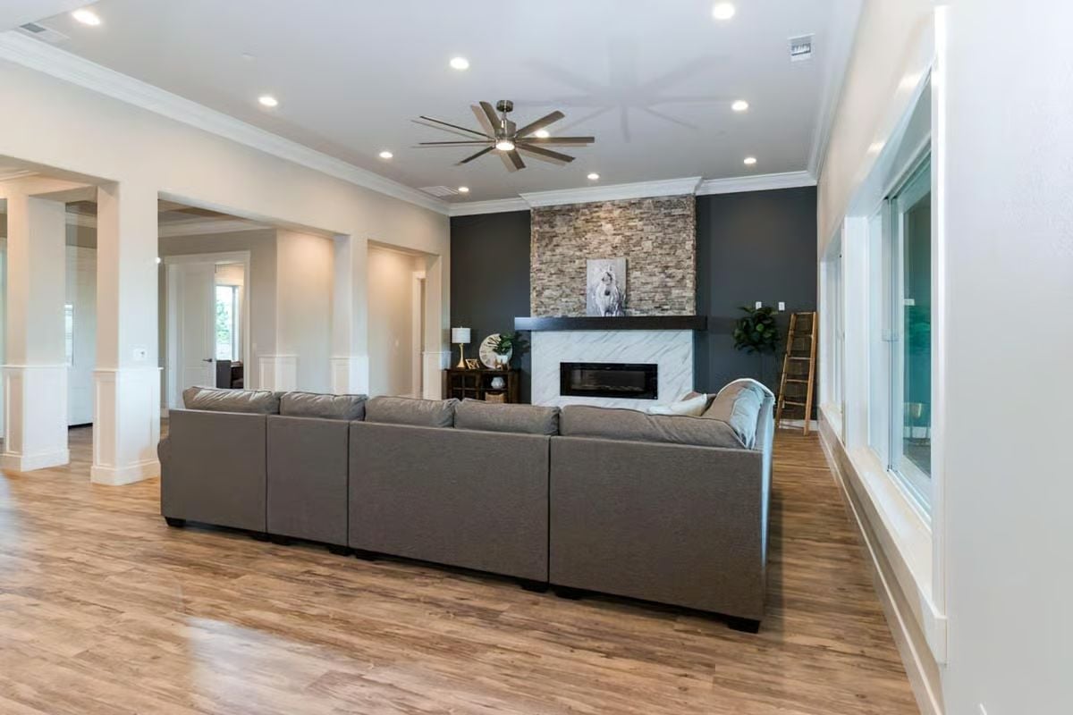 Stone Fireplace Wall Anchors an Open Living Room Built for Crowds