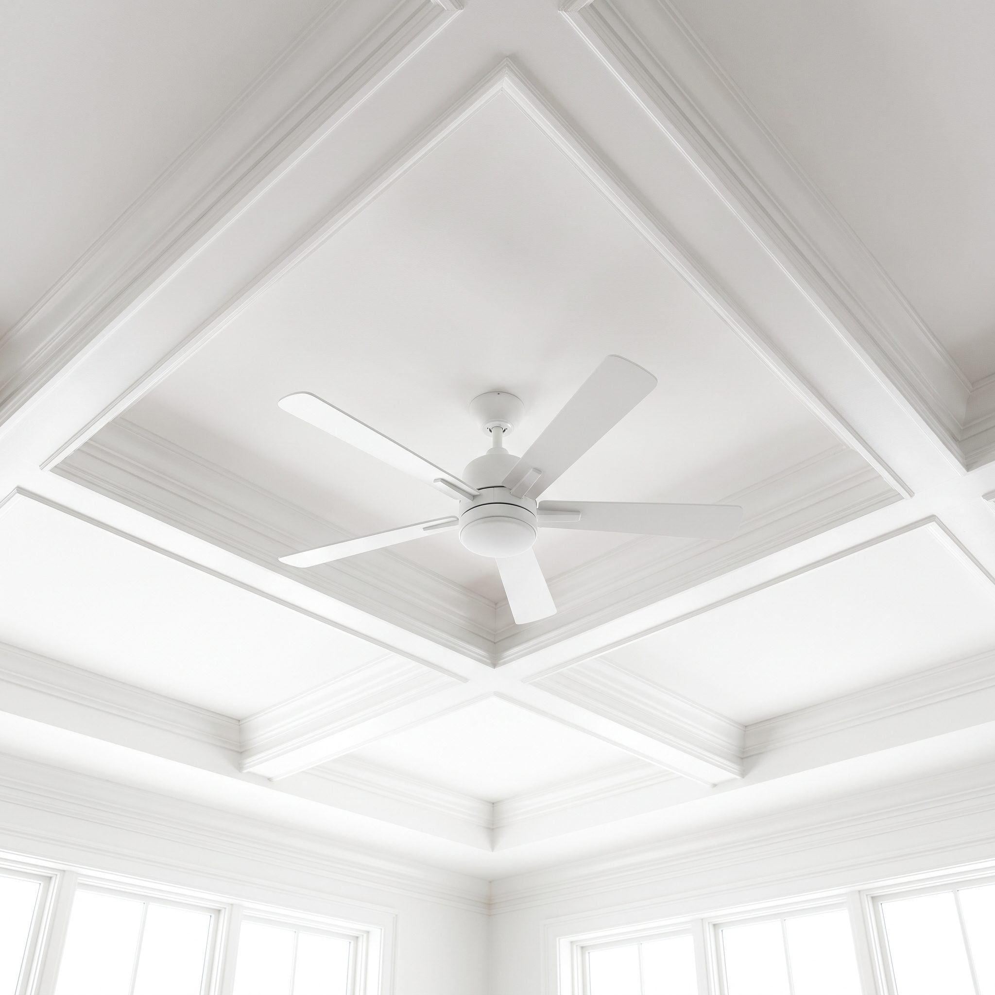 Dining room with a 52-inch white ceiling fan painted the same white as the 8-foot ceiling above an oak table.