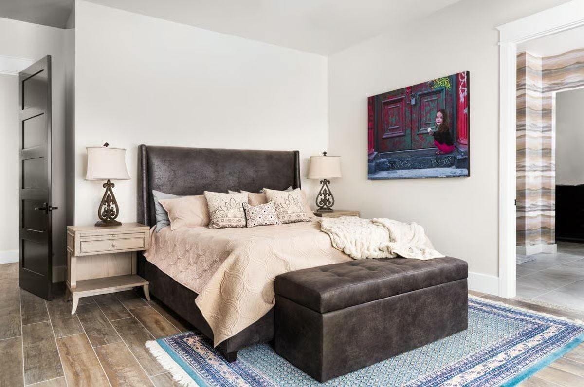 Dark Leather and a Blue Rug Ground a Bedroom That Could Belong to a Boutique Hotel