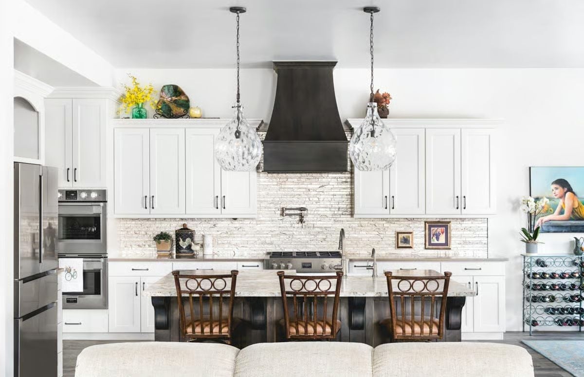 Globe Pendants and a Dark Range Hood Own the Center of This Kitchen
