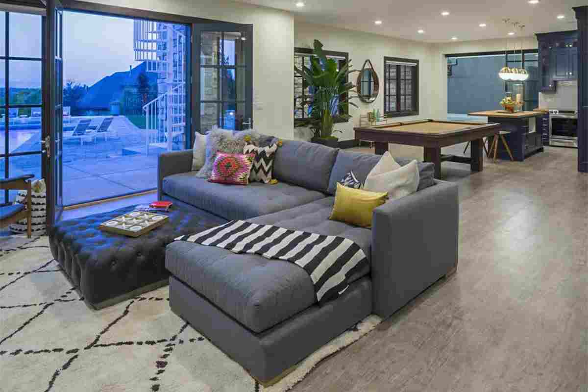 Gray Sectional, Pool Views, and a Billiard Table All Sharing One Room
