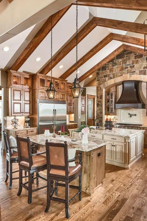 Exposed Beam Vaulting and a Stone Arch Make the Kitchen the Heart of the House