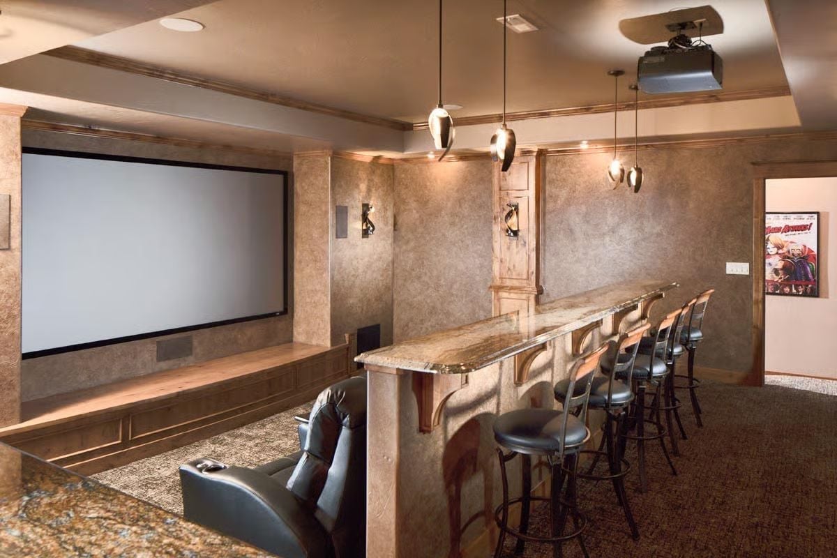 Granite Bar, Leather Recliners, and a Ceiling Projector Built for Movie Night