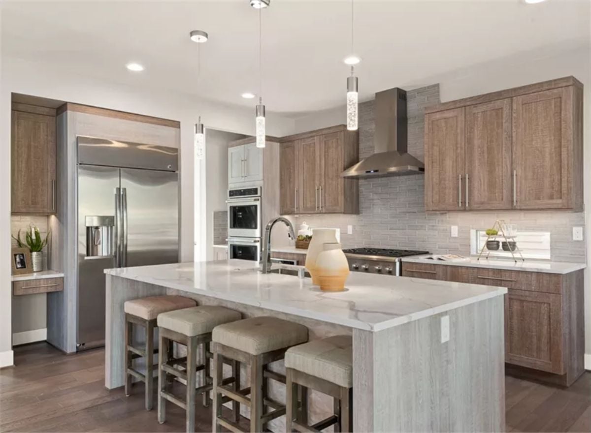 Warm Wood Cabinets and a Waterfall Island That Pulls the Whole Kitchen Together