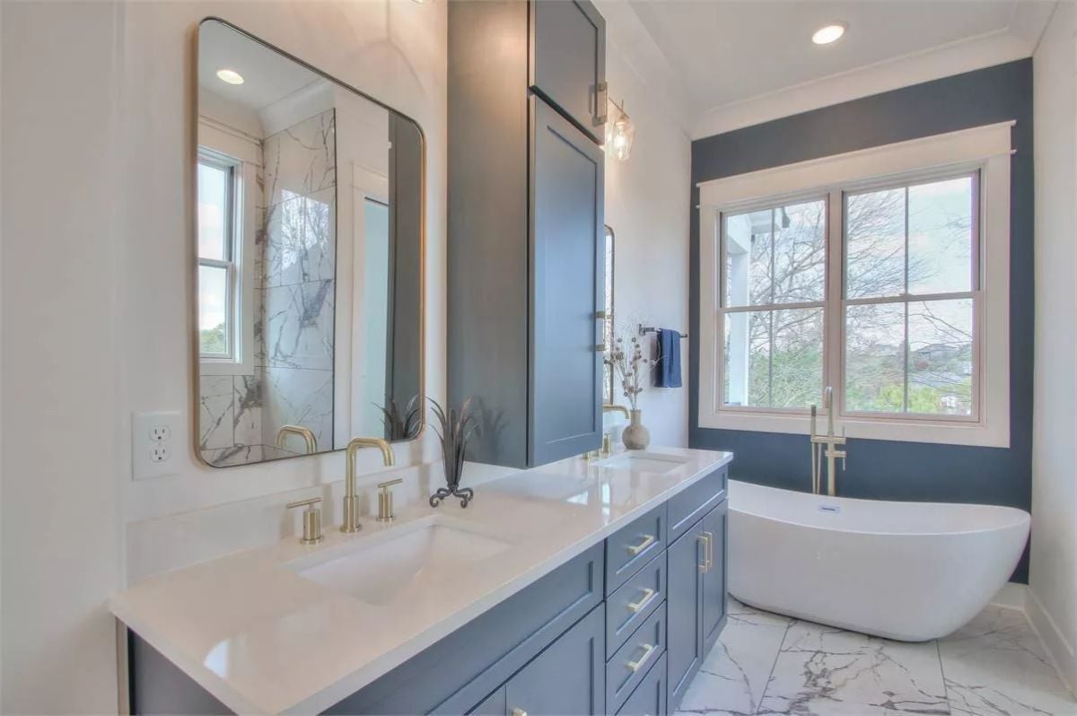 Blue Vanity Cabinets and Brass Hardware That Know Exactly What They're Doing