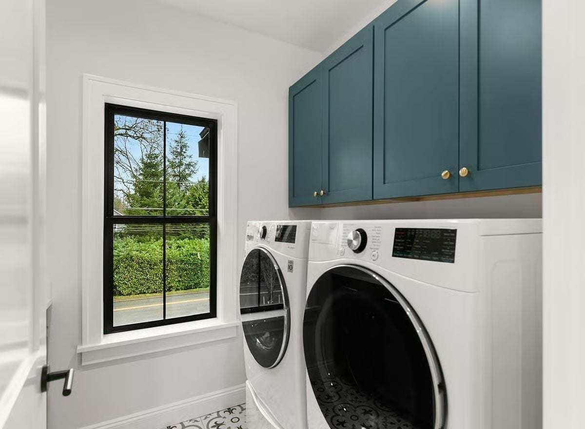 Teal Cabinets and Brass Hardware Give This Laundry Room a Reason to Exist