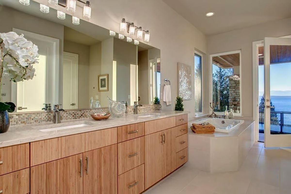 Bamboo Cabinetry, Mosaic Tile, and a Soaking Tub Aimed at the Water