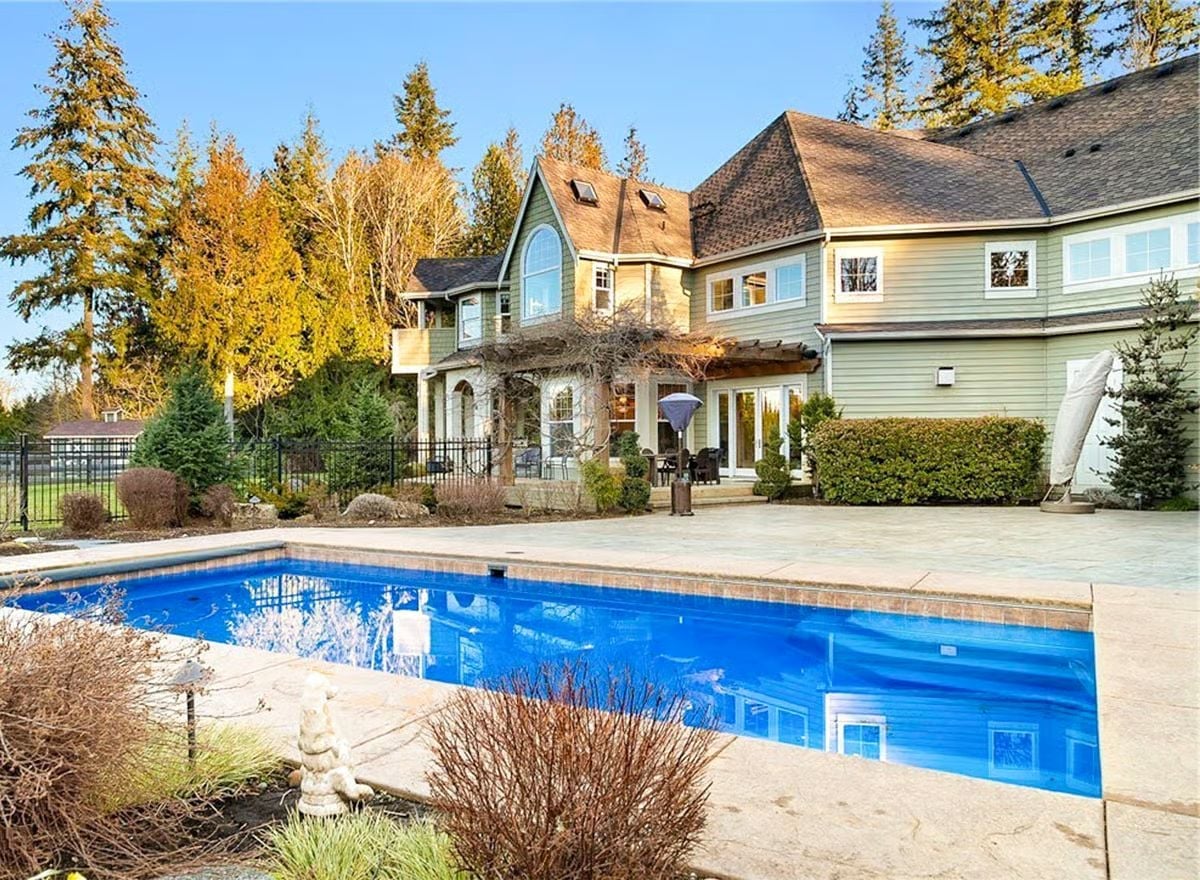 Vivid Blue Water, Stone Coping, and a Backyard That Finally Justifies the Lot Size