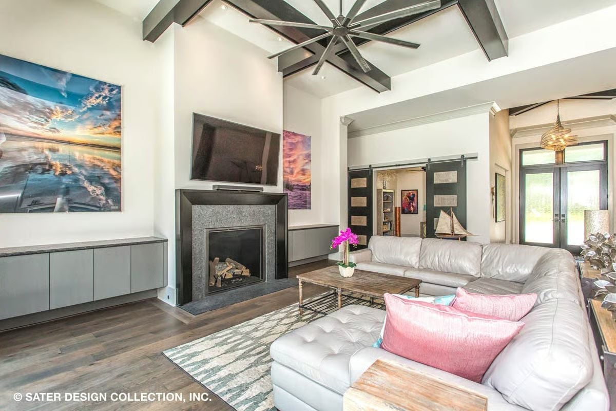 Oversized Ceiling Fan, Dark Beams, and a Fireplace That Commands the Wall