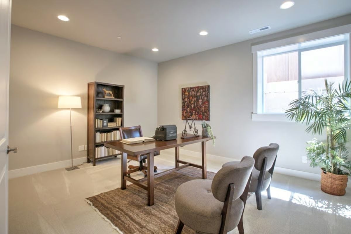 Bookshelf, Vintage Typewriter, and Two Guest Chairs Make This Office Actually Usable