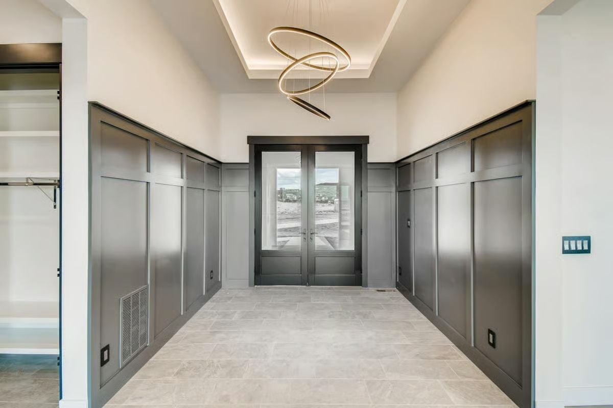 Gold Rings and Gray Panels Make This Foyer Hard to Forget
