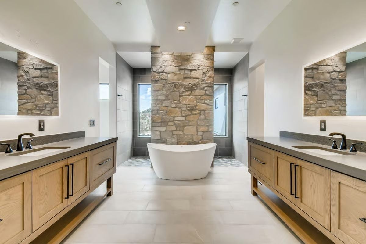 Soaking Tub, Stone Column, and Two Vanities That Don't Share a Wall