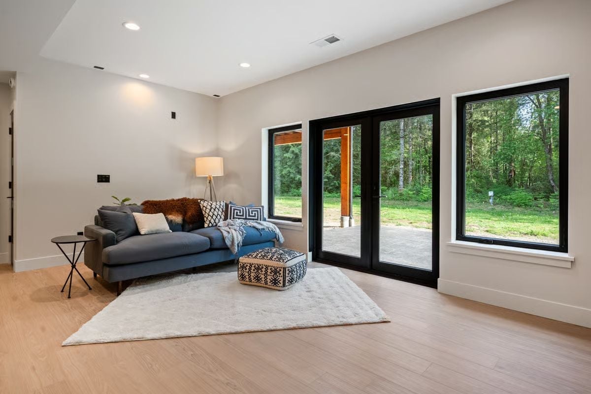 Black Frames, Forest Views, and a Living Room That Brings the Outside In