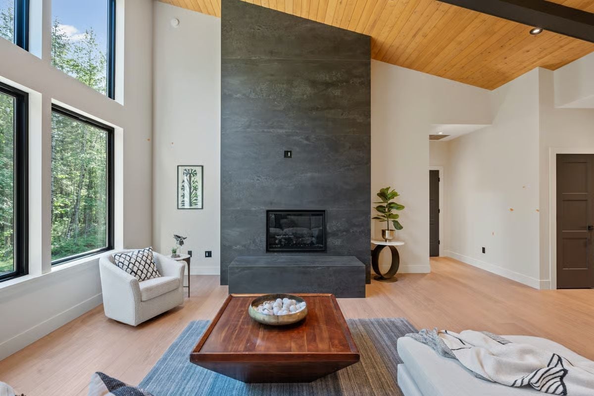 Concrete Surround, Wood Ceiling, and a Fireplace That Anchors the Room