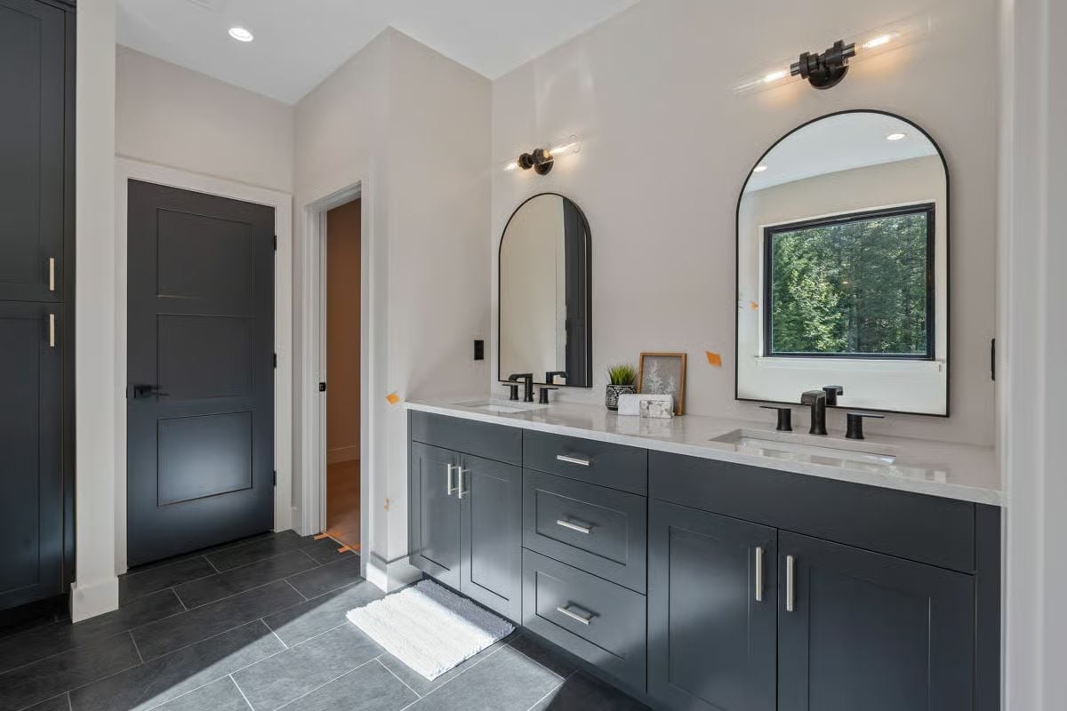 Slate Tile, Arched Mirrors, and a Double Vanity That Pulls Its Weight