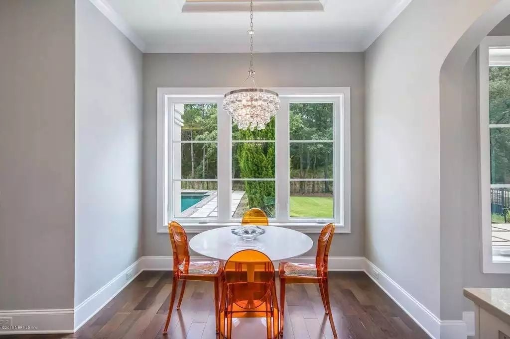 Translucent Orange Chairs Against a White Tulip Table Pull Off Something Rare