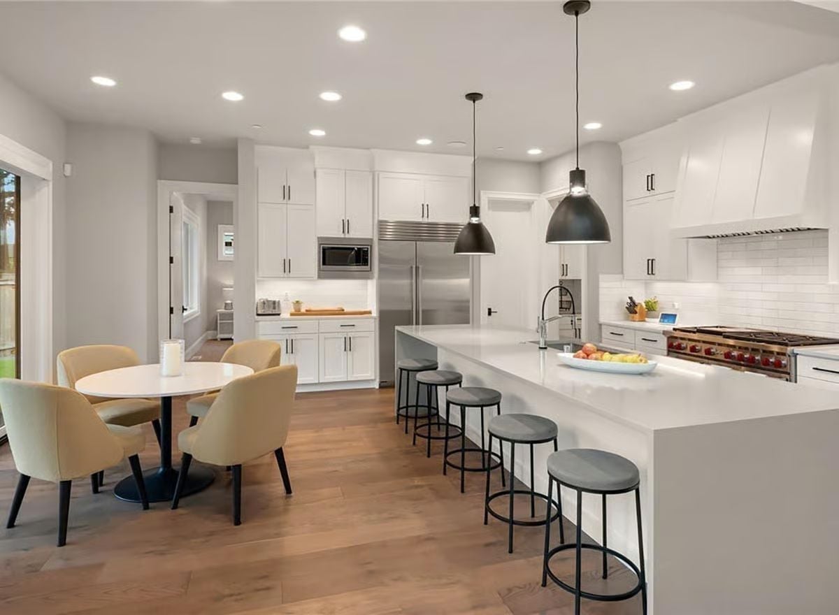 White Quartz Island Long Enough to Seat Five Without Anyone Touching Elbows
