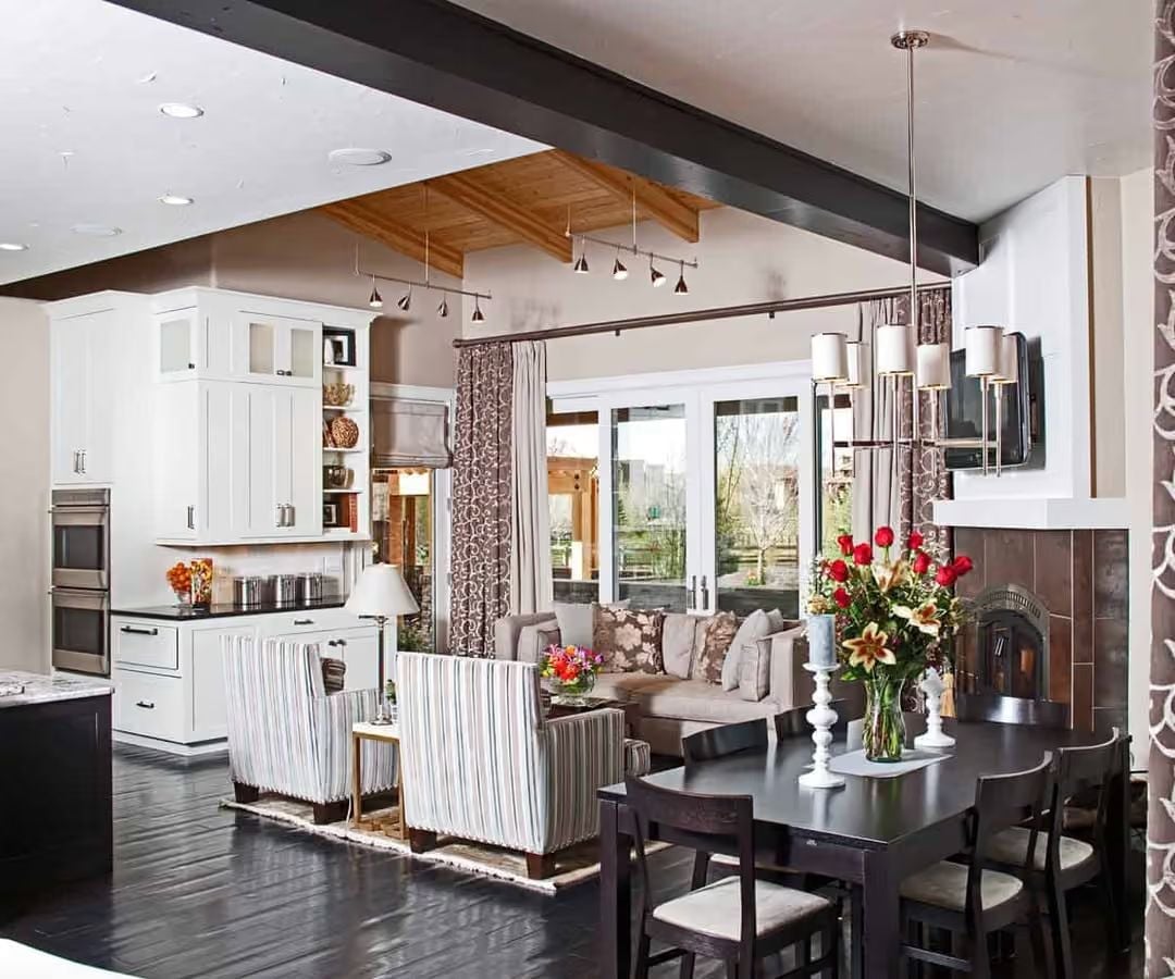Dark Floors and White Cabinetry Pull Double Duty in This Open-Plan Kitchen and Dining Space