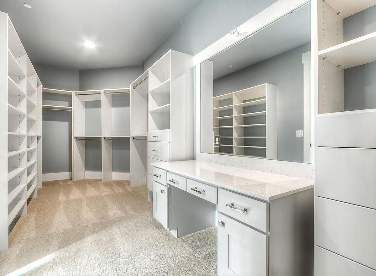 Built-In Vanity and Lighted Mirror Give This Walk-In Closet a Dressing Room Feel
