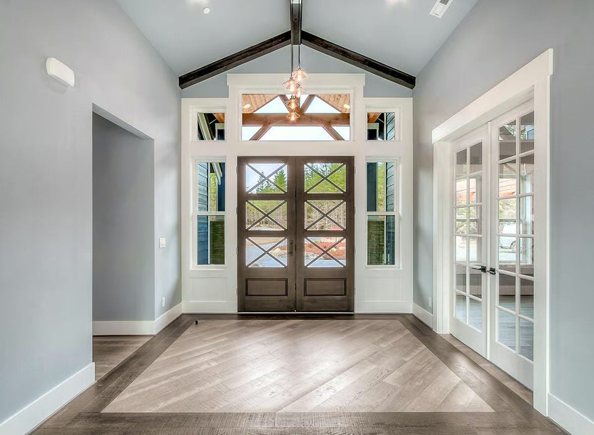 Vaulted Foyer with Dark Wood Beams and Craftsman Double Doors