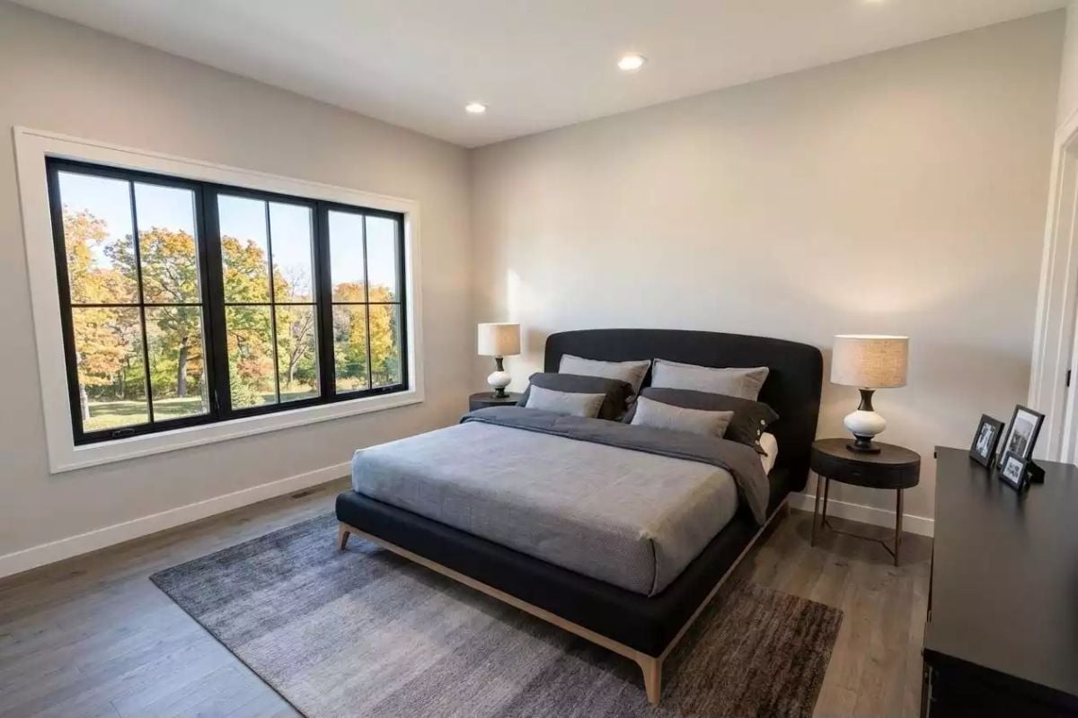 Charcoal Upholstered Bed, Matching Lamps, and a Window That Makes Fall Do the Decorating