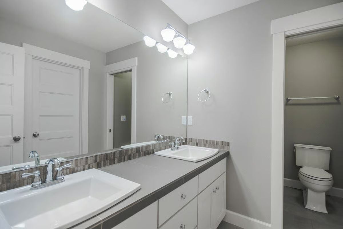 Double Sinks and a Mosaic Backsplash Strip That Earns Its Keep