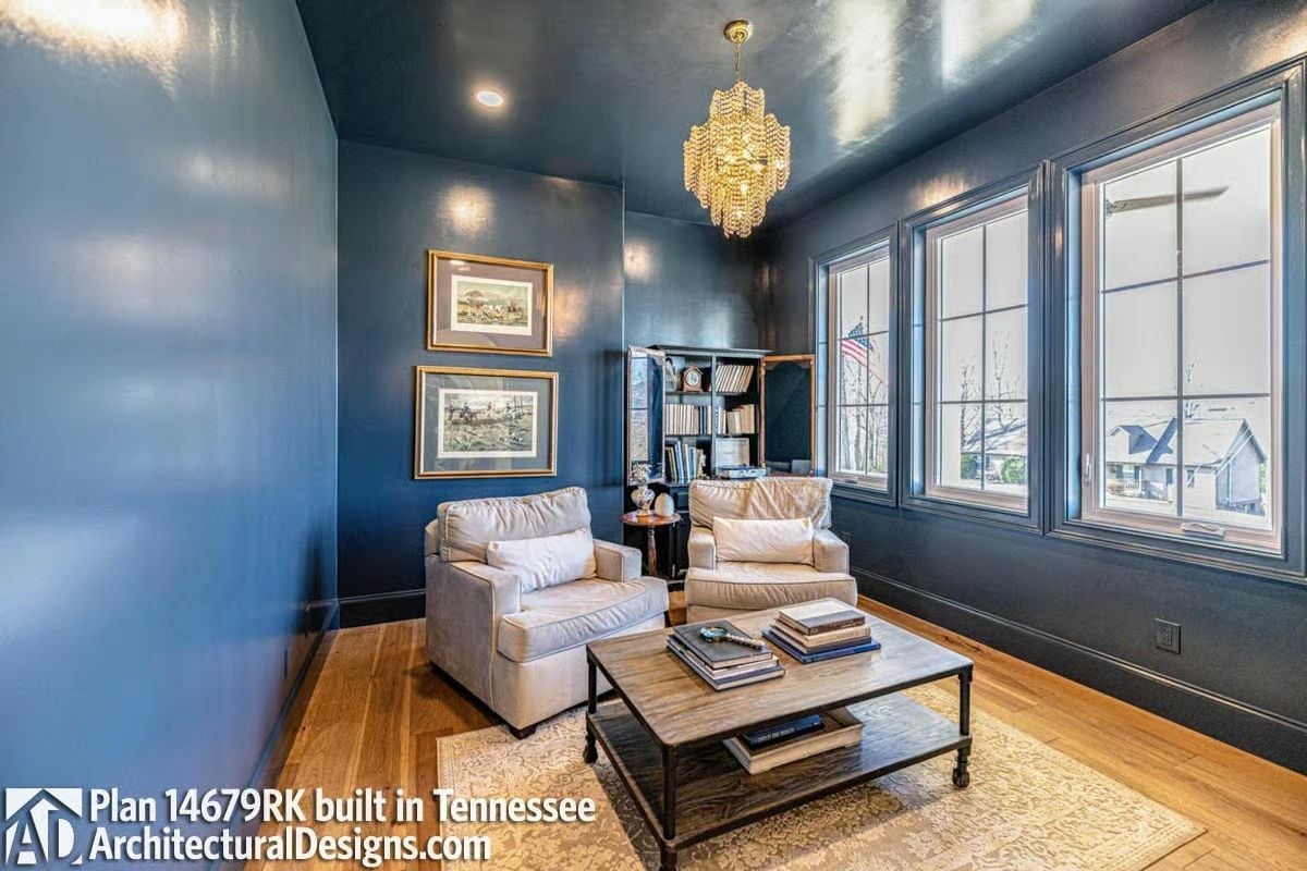 Glossy Navy Walls and a Crystal Chandelier Make the Study Feel Intentional