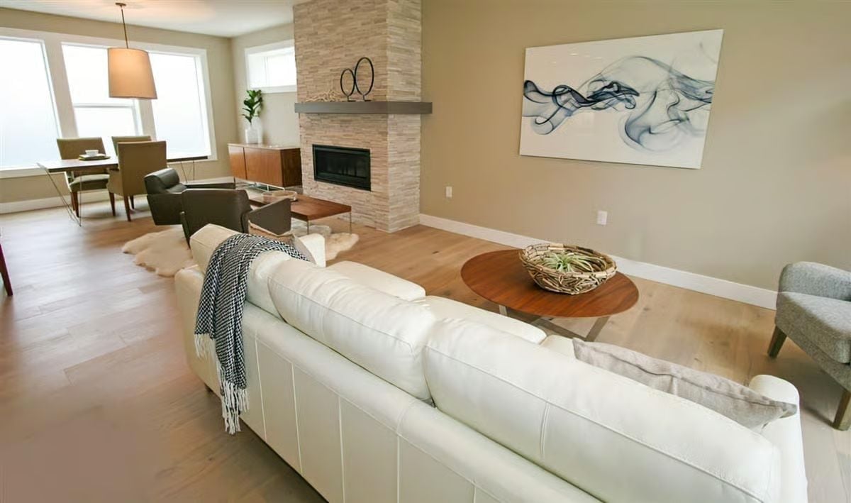 White Leather and Stacked Stone Pull This Living Room in Opposite Directions (It Works)