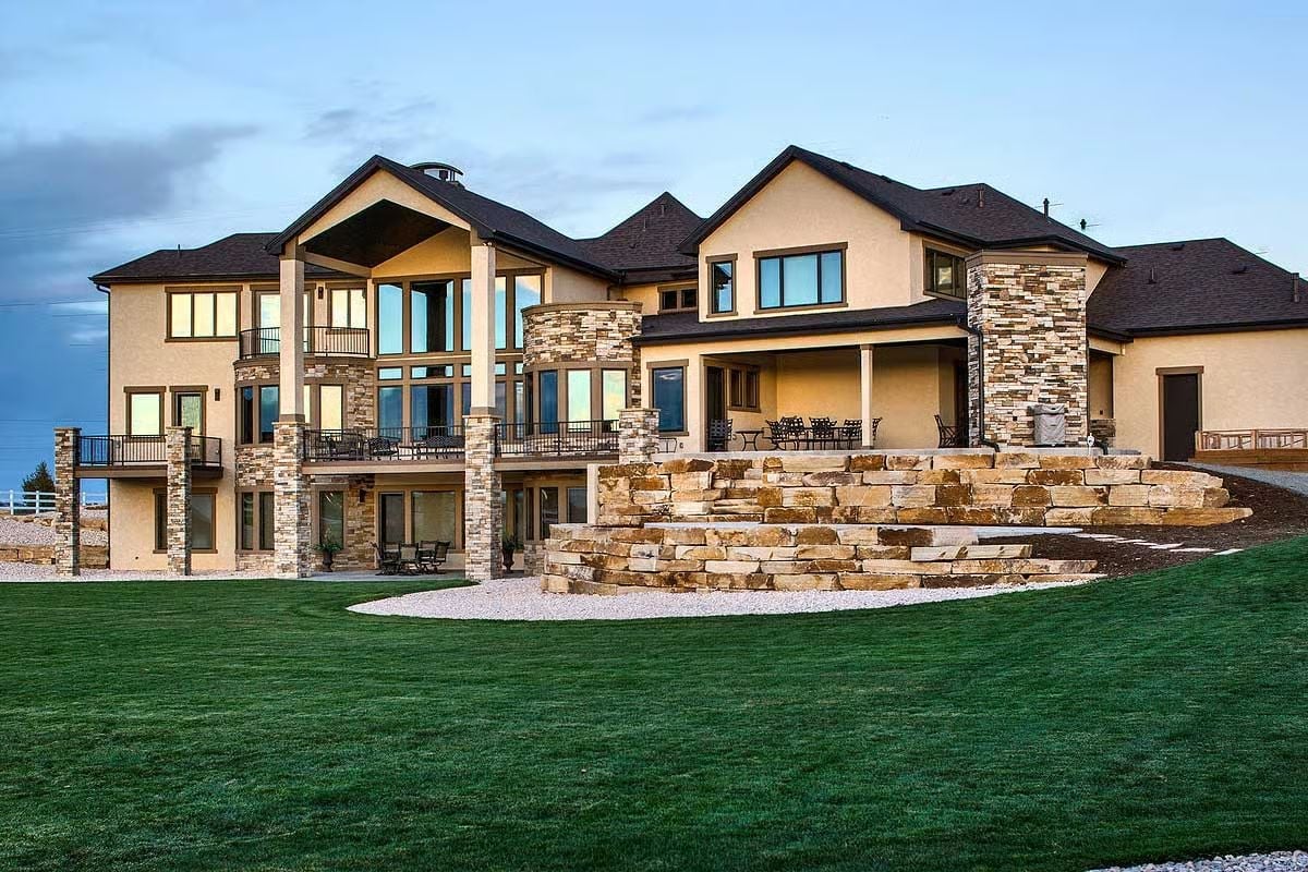 Stacked Stone Columns and Three Tiers of Outdoor Living Define This Mountain Manor
