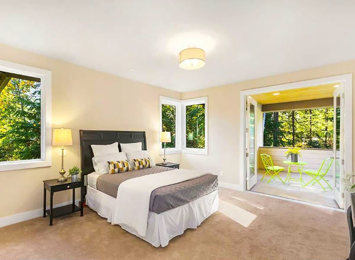 Chartreuse Chairs and Corner Windows Make This Bedroom Worth Waking Up In