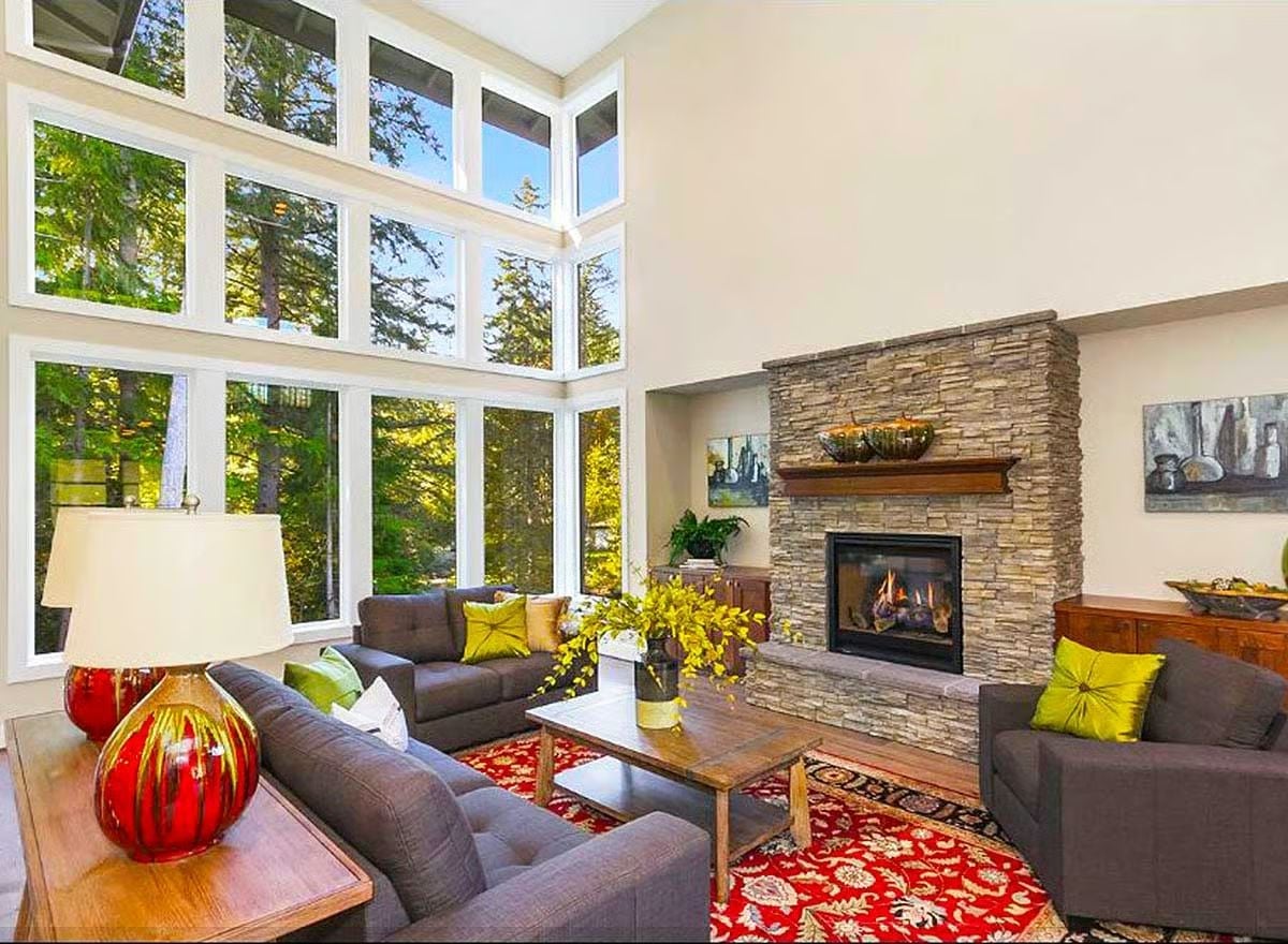 Stone Fireplace and Two-Story Windows Make the Great Room Feel Like a Treehouse