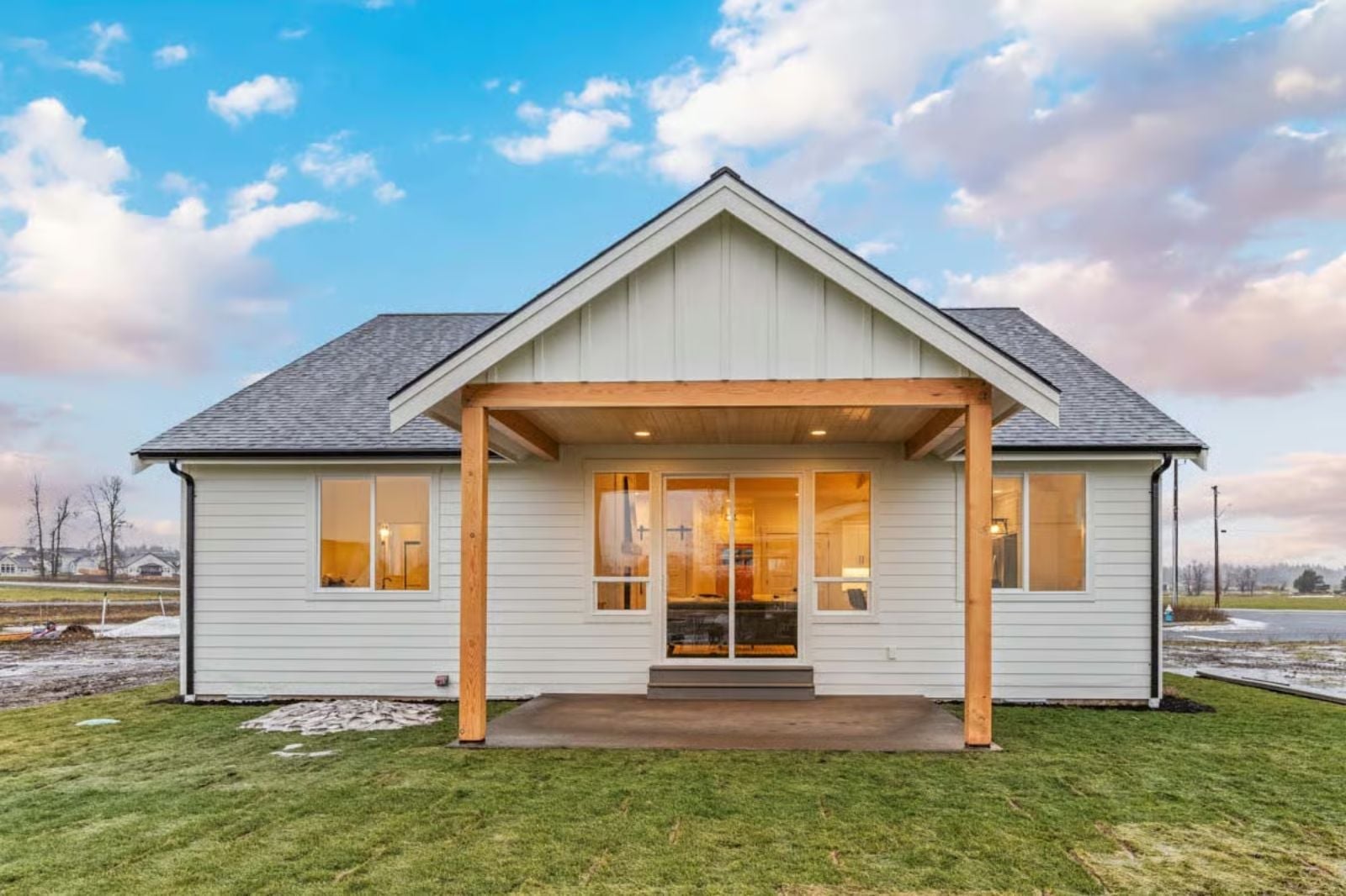 Covered Patio Posts, Warm Glass, and a Back Elevation That Earns the Lot