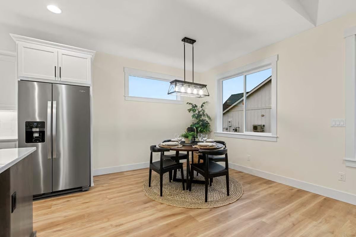 Stainless, Black Chairs, and a Round Table That Makes the Corner Feel Intentional