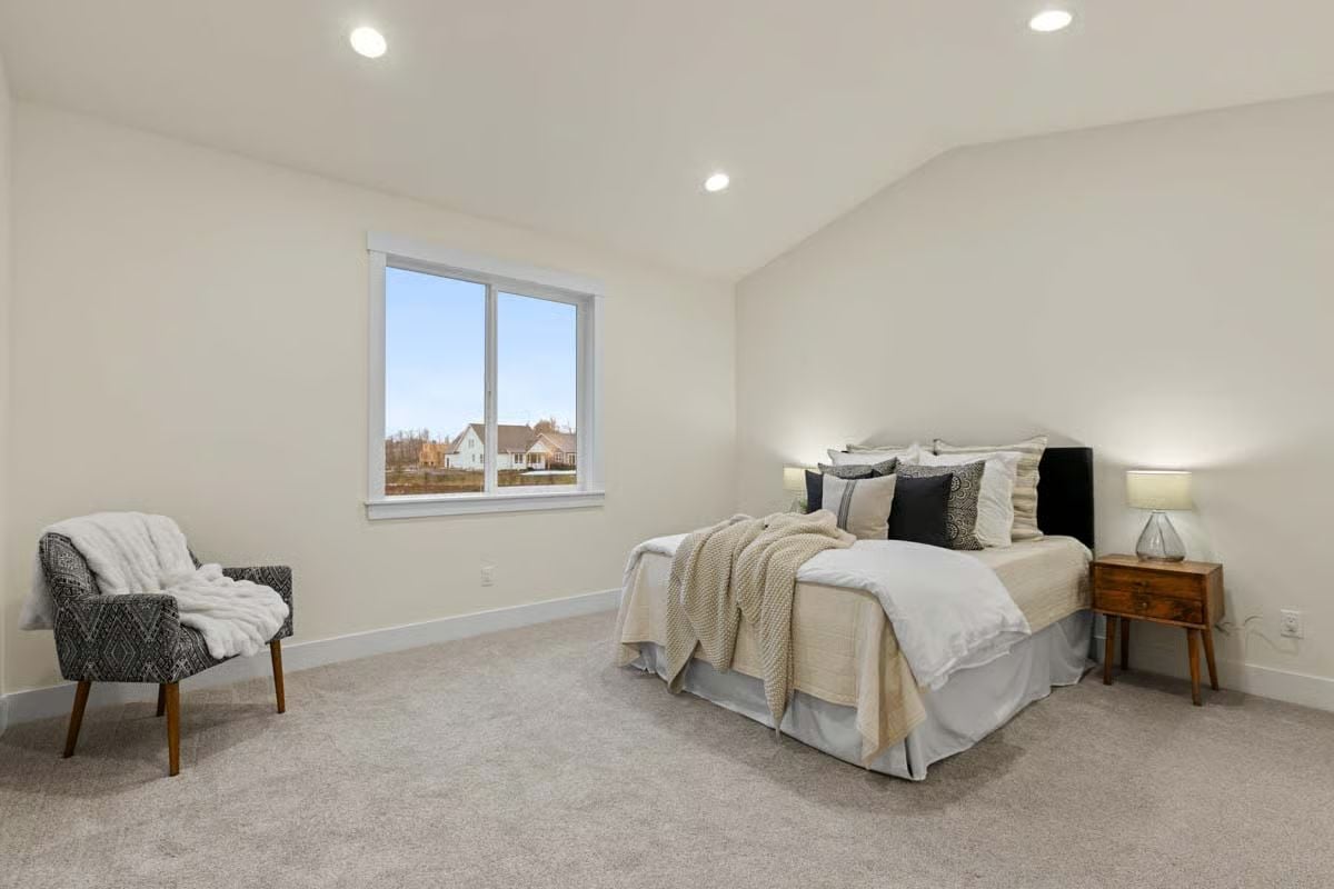 Vaulted Ceiling, Gray Carpet, and a Knit Throw That Makes the Chair Look Like a Trap