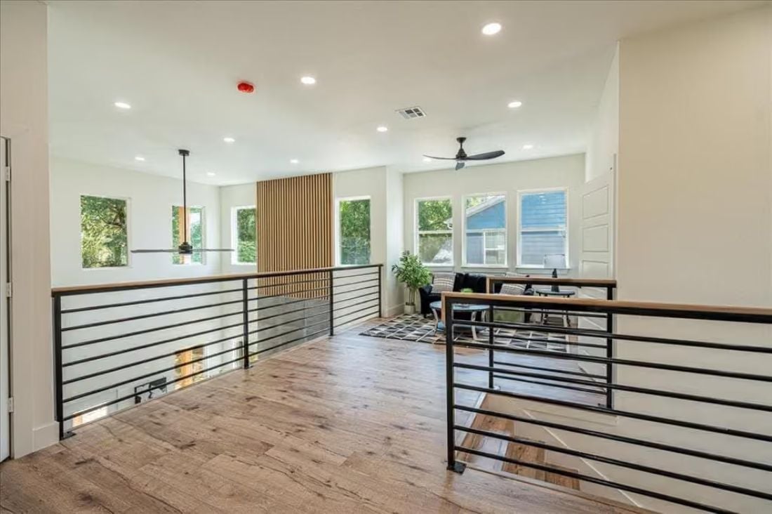 Horizontal Railings and a Slatted Wood Panel Turn a Loft Hallway Into a Design Moment