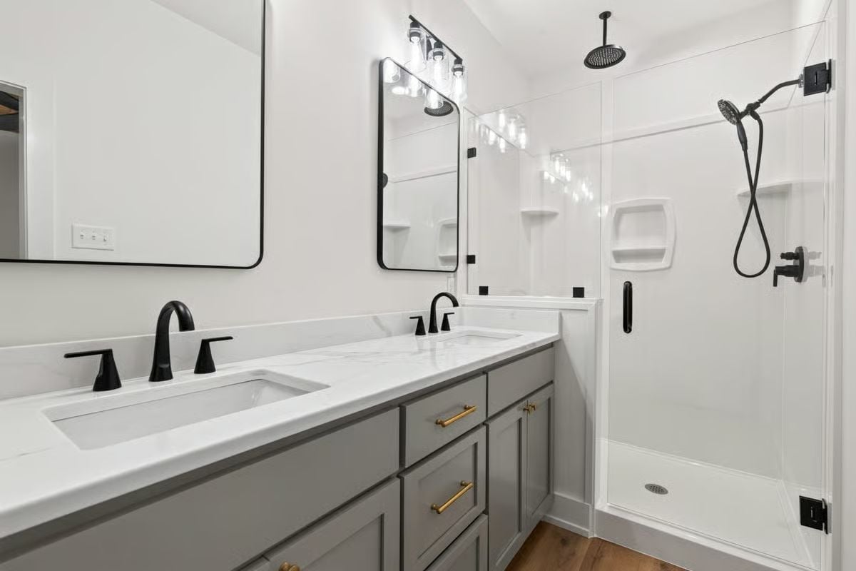 Matte Black Fixtures Pull Double Duty Against White Quartz and Gray Cabinetry