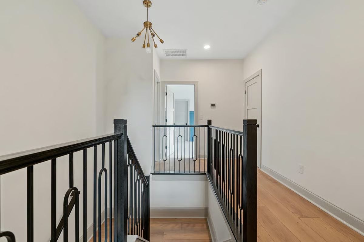 Matte Black Railing With Oval Balusters on an Upper-Floor Landing That Earns a Second Look