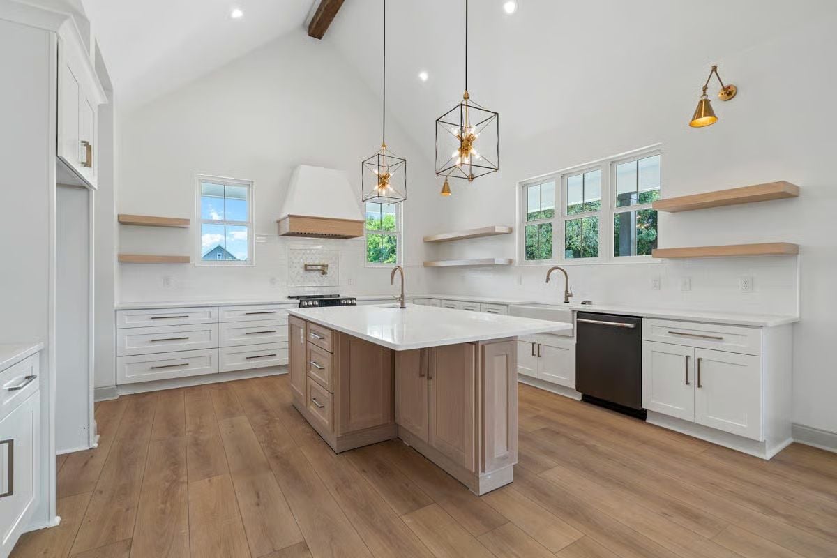 Warm Island Cabinetry in a Sea of White That Keeps the Kitchen from Feeling Cold