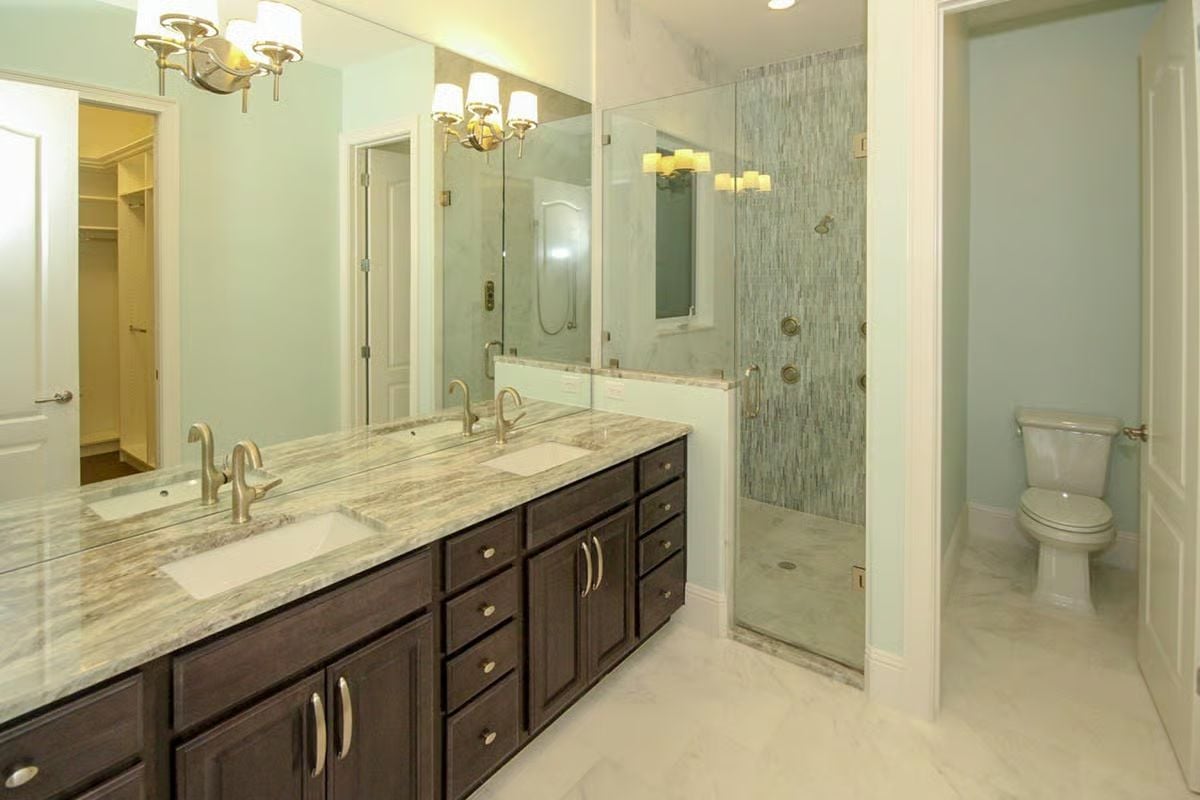 Espresso Vanity and Veined Marble Counter in a Bath That Earns Its Square Footage