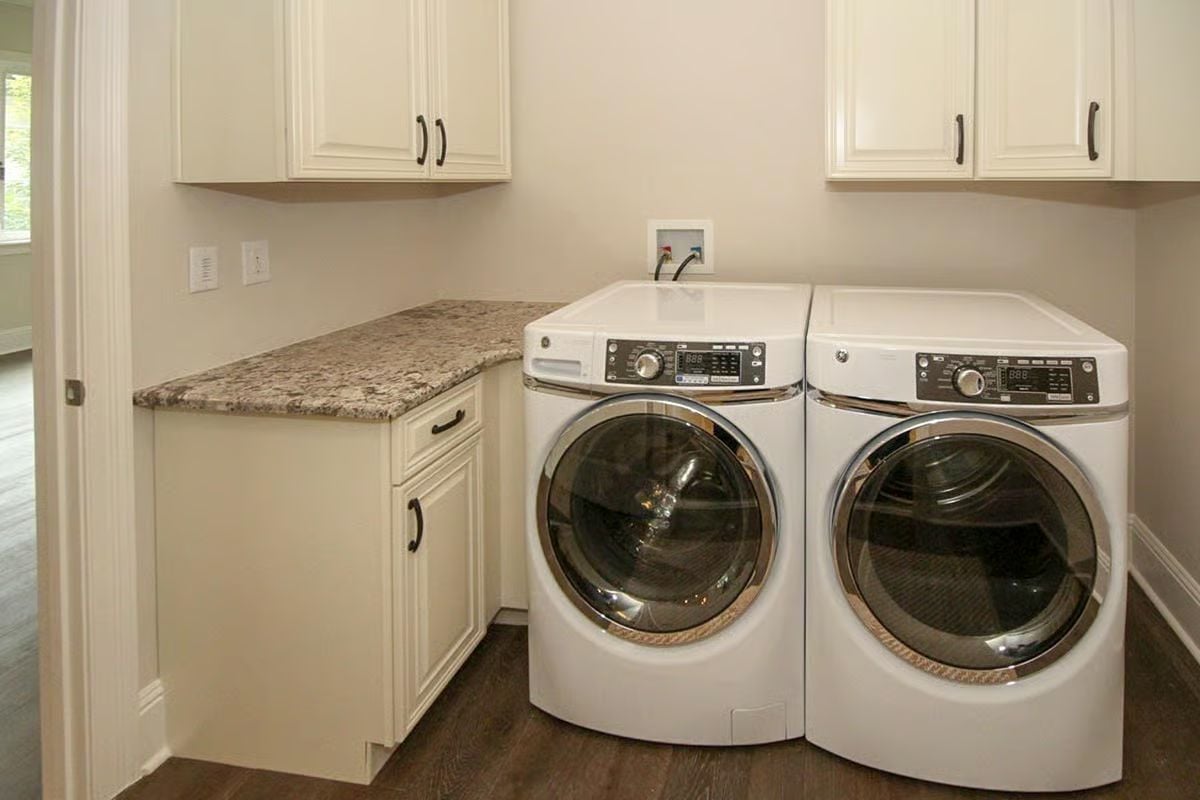 GE Front-Loaders and Granite Folding Space in a Laundry Room That Works Hard