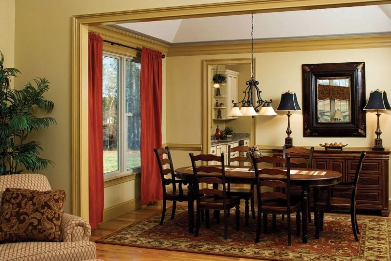 Red Curtains and a Wrought-Iron Chandelier That Set the Whole Mood