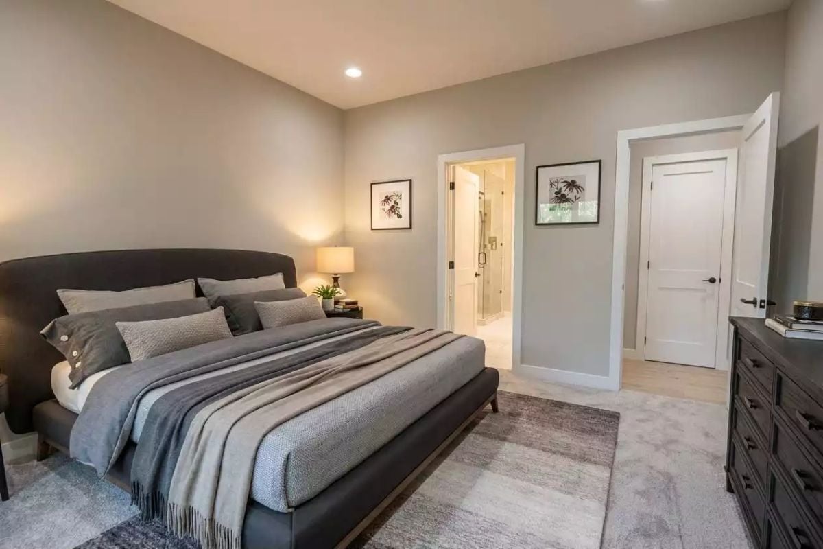 Dark Upholstery, Layered Linens, and a Bedroom That Locks From the Inside