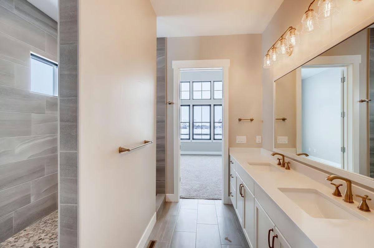 Brass Fixtures and Pebble Tile Floor Give This Shower Walkthrough Real Character
