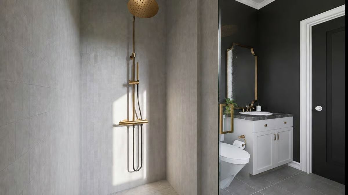 Brass Fixtures and Dark Walls Turn a Split Bathroom Into Two Different Moods