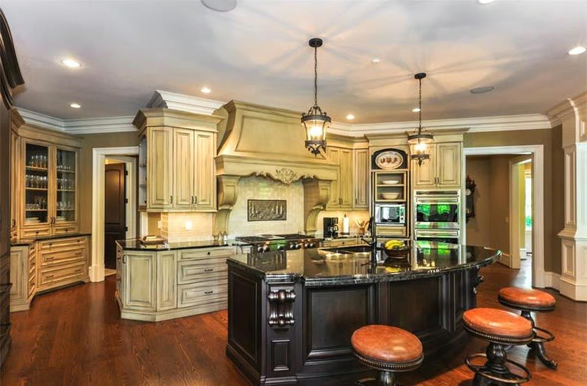 Ornate Range Hood, Black Marble Island, and Leather Stools That Earn Their Keep