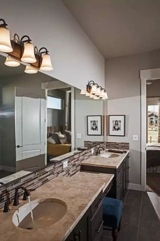 Double Vanity With Mosaic Tile Backsplash That Holds Its Own Against the Stone Counter