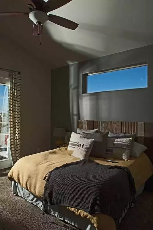 Reclaimed Wood Headboard and a Clerestory Window That Pulls In Sky Without Sacrificing Privacy